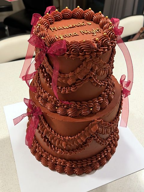 Two-tier chocolate vintage cake with burgundy organza bows for a henna night