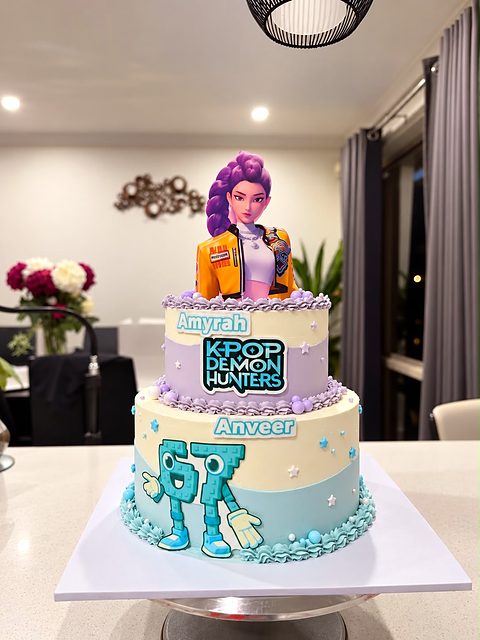 Two-tier K-Pop Demon Hunters themed birthday cake