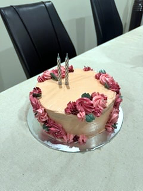 Birthday cake with pink rosettes
